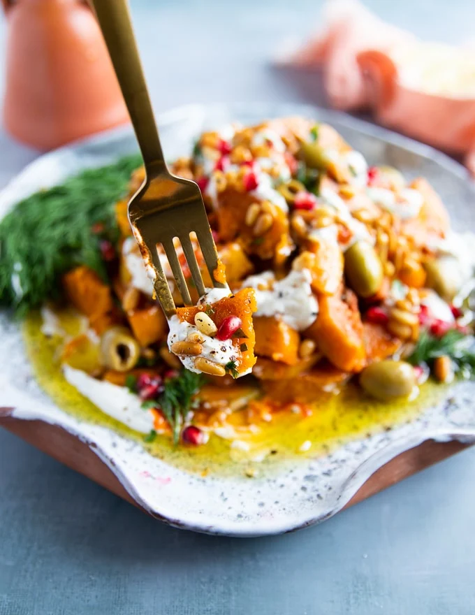 A fork showing a whole bite of the honeynut squash recipe showing all ingredients together