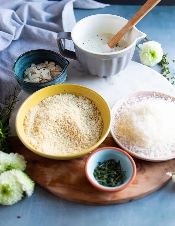 ingredients for the casserole topping including panko, Parmesan cheese, herbs, nuts and seasoning