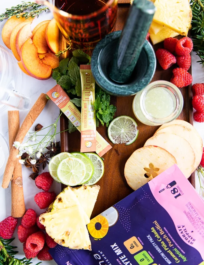 ingredients to make the pineapple mojito including pineapple replenishers, lime juice, mint, fresh pineapple and soda water