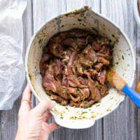 the fajita meat added to the bowl of marinade and tossed well to coat