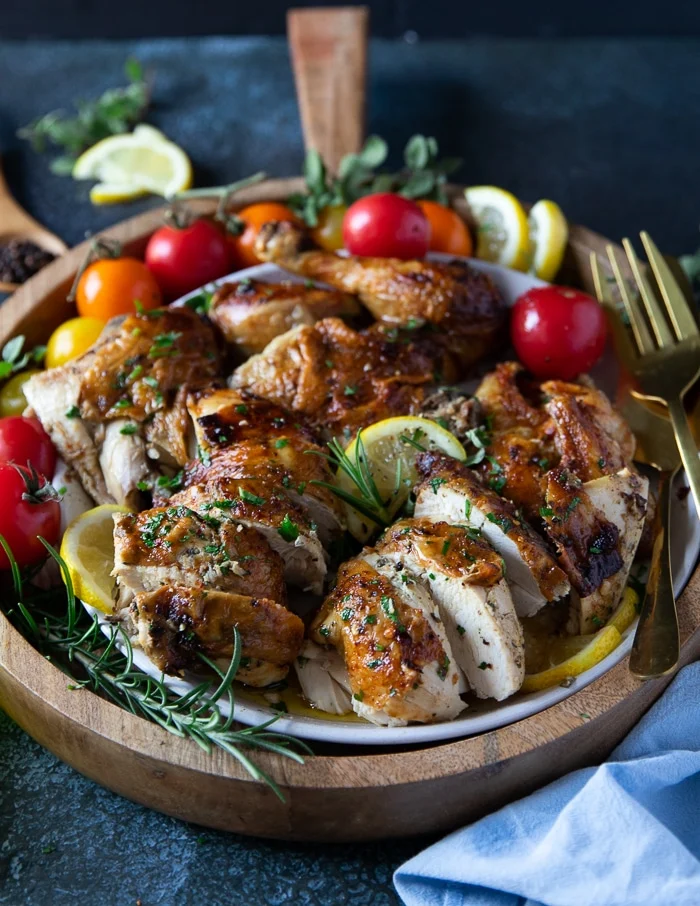 cutting up a whole chicken into pieces to serve on a plate