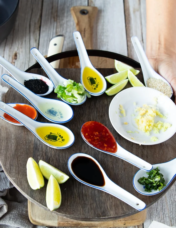 ingredients for the fresh tuna marinade including fresh ginger, garlic, soy sauce, hot sauce, lime juice, scallions, sesame oil, chilli sauce