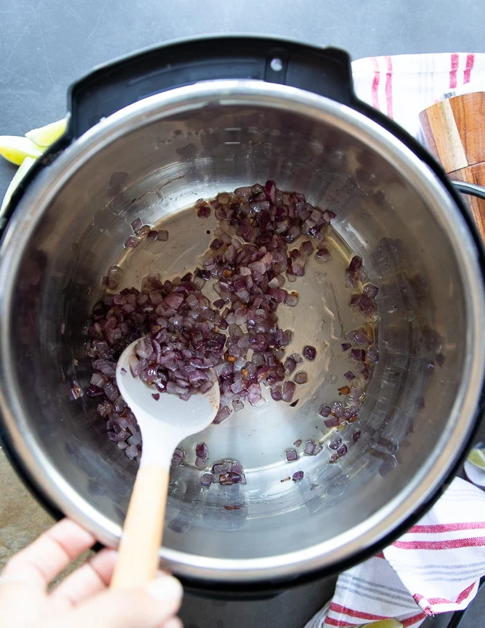 Onions being sautéed to make the birria stew