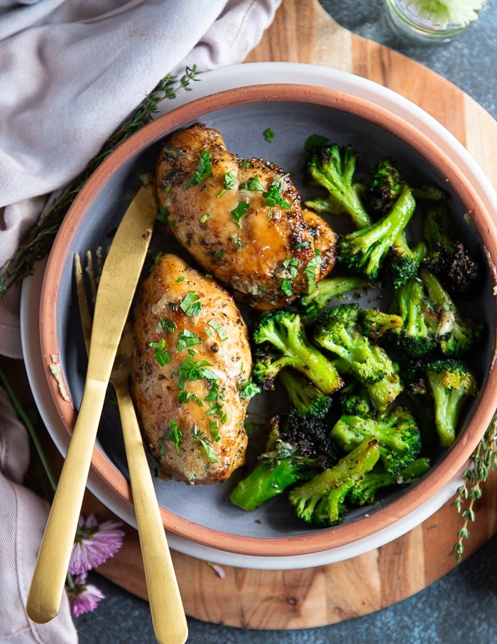 close up of chicken breasts right out of the air fryer and sprinkled with some parsley showing how golden it is on the outside
