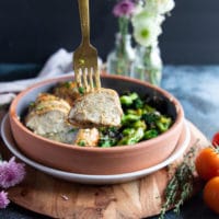 A fork holding up a cut up piece of air fryer chicken breast to show how well cooked and juicy the chicken breast is