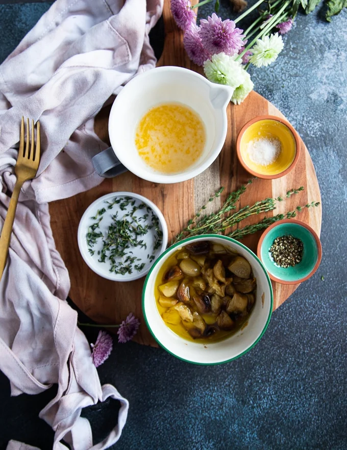 the butter roast garlic spread to the air fryer chicken breast including melted butter, roast garlic, seasoning and fresh herbs