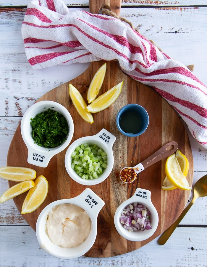 ingredients for lobster roll including mayo, celery, parsley, lemon juice, onions, chilli flakes
