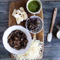 Ingredients for mushroom pizza: kale, cremini mushrooms, brie, mozzarella, and light cream cheese.