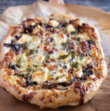 Top-down view, close-up mushroom pizza on a pizza peel.