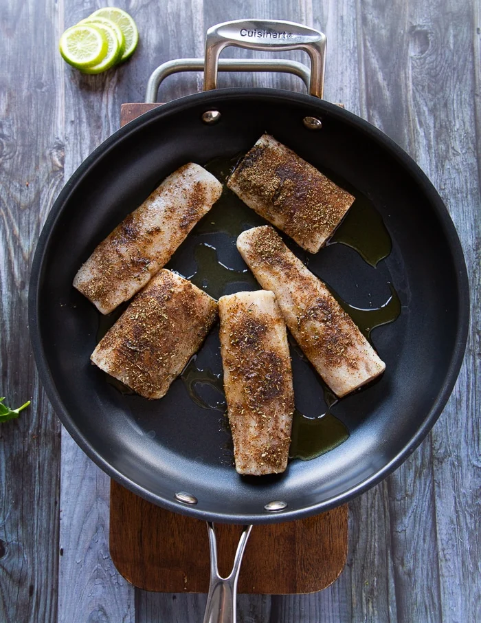 mahi mahi fish in a skillet cooking