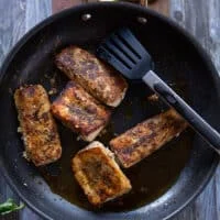 Perfectly cooked mahi mahi fish in a skillet, all crispy and browned up