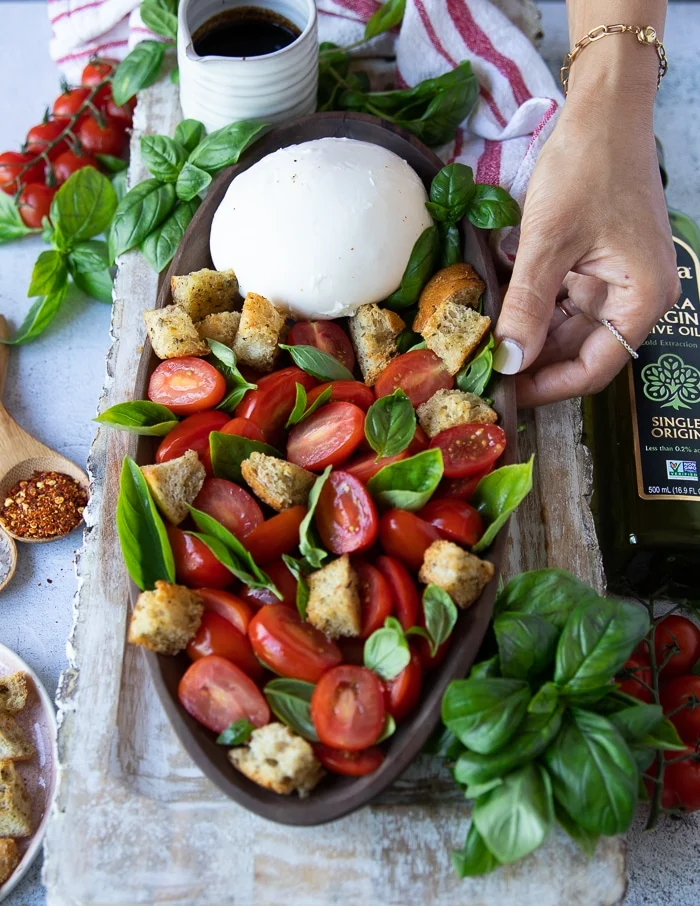 croutons are added to the burrata caprese salad