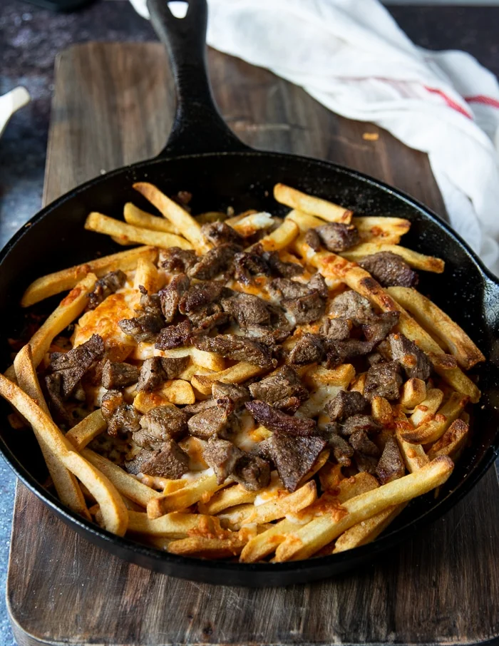 the pan is broiled and the cheese has melted over the fries and the meat has a crust