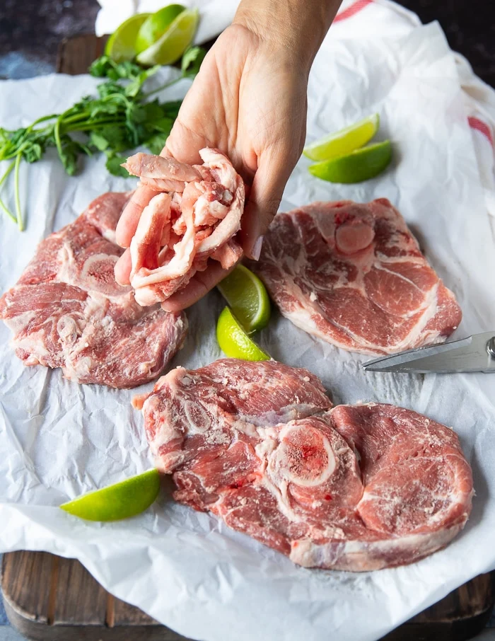 The trimmed excess fat shown on a board and to be stored for use in more recipe later