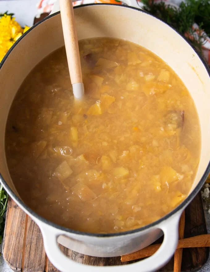 The homemade apple cider has finished simmering and is now ready to sweeten and strain