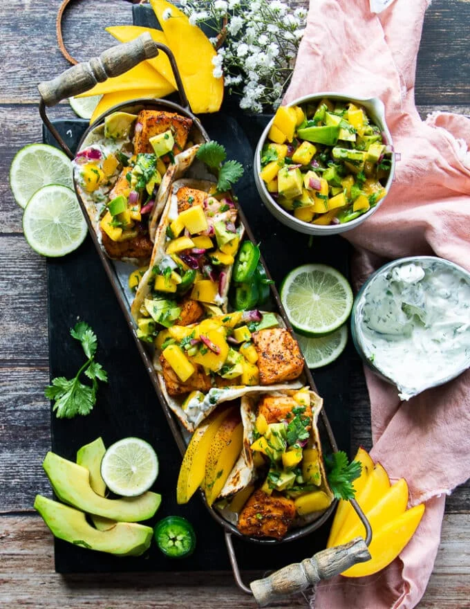 the final platter of salmon tacos with all the tortillas assembled into salmon tacos with salmon and salsa