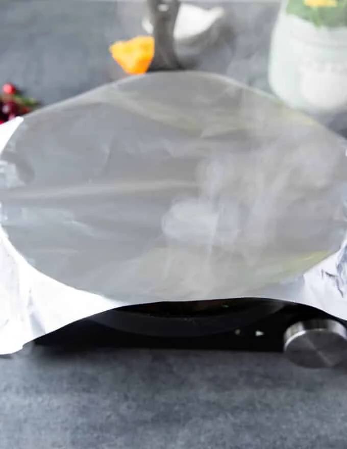 turkey tenderloin covered in foil and ready to roast in the oven.