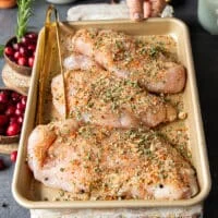 turkey tenderloins in a sheet pan seasoned with the dry seasoning spice mix