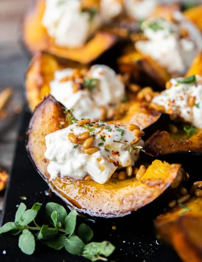 close up of one wedge of the sweet roasted acorn squash showing the golden caramelized squash