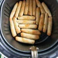 Golden and crisp taquitos ready in the air fryer basket
