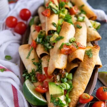 close up of air fryer taquitos in a plate showing how crisp the texture is