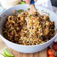 The cheese is now added to the same bowl of the taquitos filling and mixed in using a wooden spoon until evenly distributed