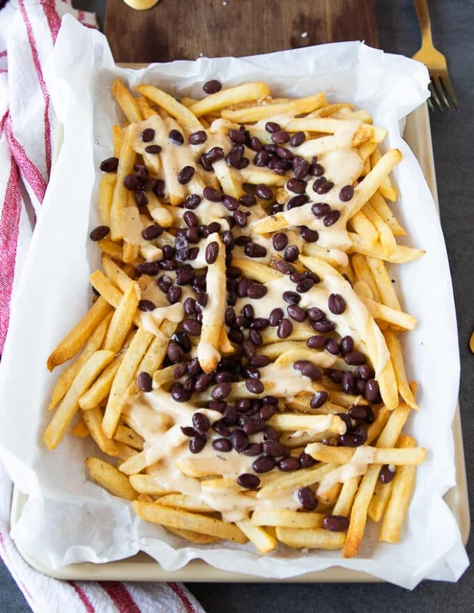 Loading up the nacho fries starting with cheese, taco beef and beans