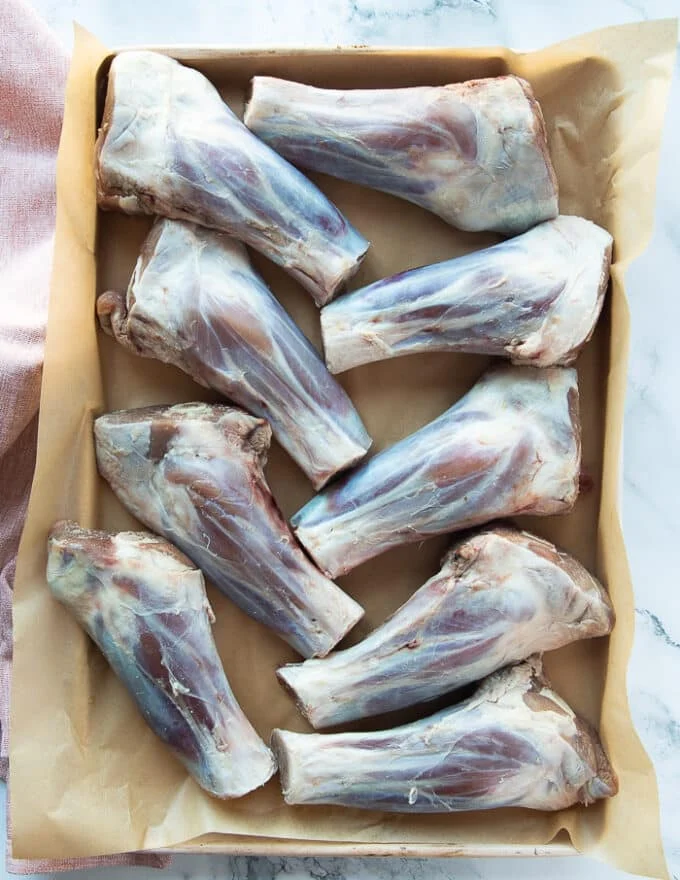 A tray of lamb shanks trimmed and patted dry