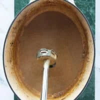 An immersion blender used to make the braising liquid turn into a smooth soft gravy