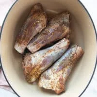 Lamb shanks in a heavy duty dutch oven pan for searing
