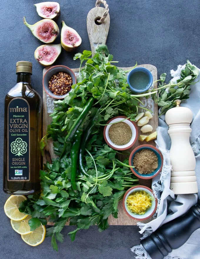 Ingredients for chermoula sauce including: olive oil, lemon juice, parsely, cilantro, green chillies, cumin, salt, pepper, chili flakes, garlic, ginger