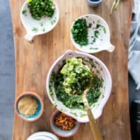 Ingredients mixed in a bowl to flavor the sardines which include garlic, herbs, olive oil and lemon and seasoning