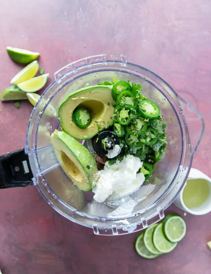 Avocado crema ingredients in a food processor
