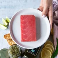 A block of fresh Saku tuna on a plate to make carpaccio