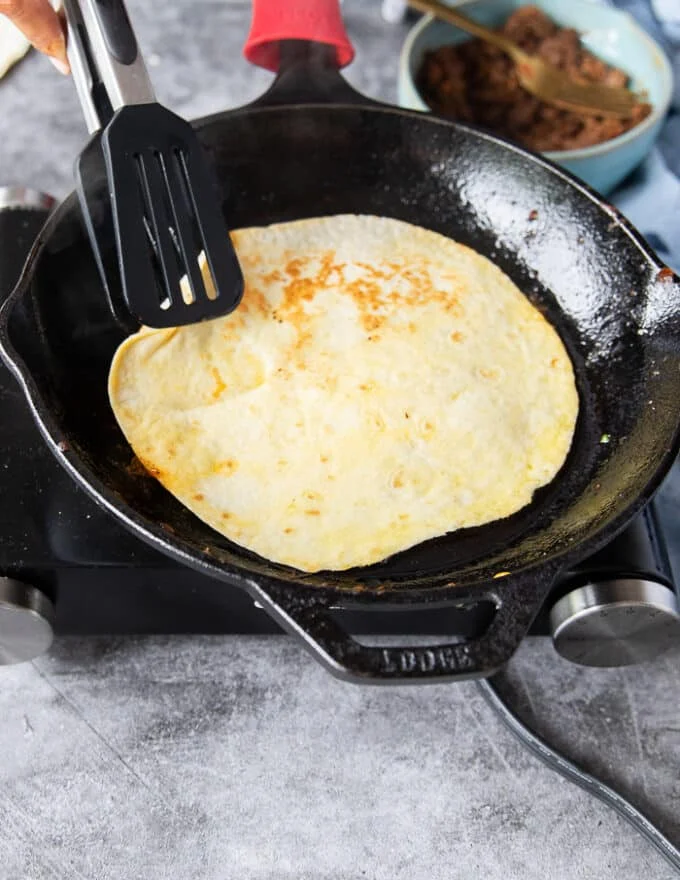Flipped tortilla ready to start assembling the birria quesadillas