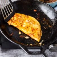 Tortillas is now folded in half to look like a quessadilla and then flipped to have a nice golden color on both sides