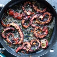 Octopus tentacles on the grill showing how to grill octopus