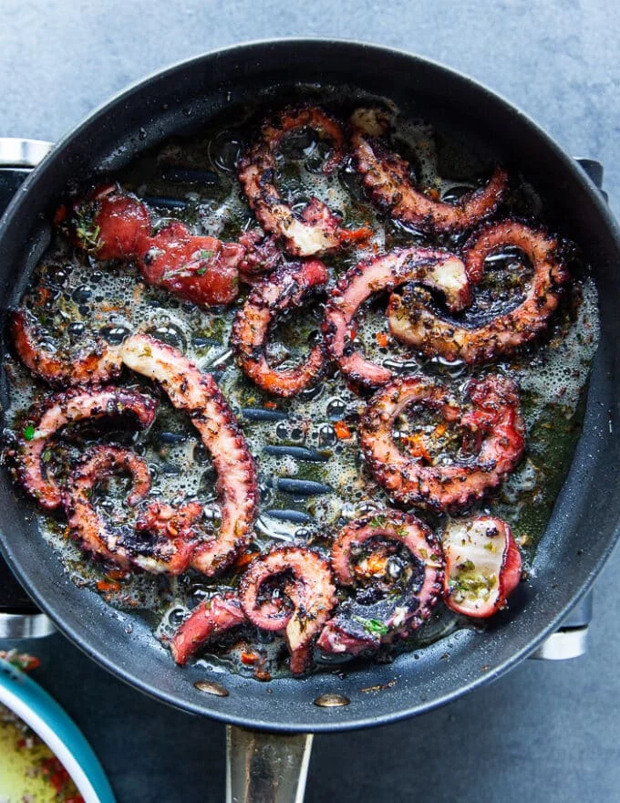 Octopus tentacles on the grill showing how to grill octopus