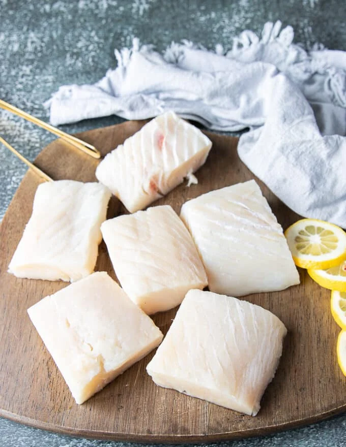 Halibut fillets on a wooden board