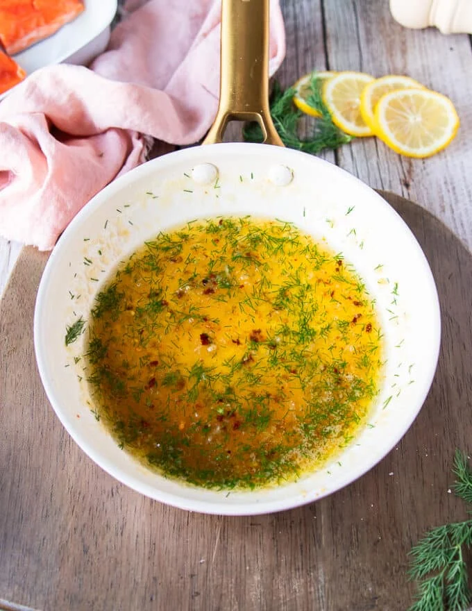 The honey glaze is ready in a skillet with the added dill, lemon and soy sauce