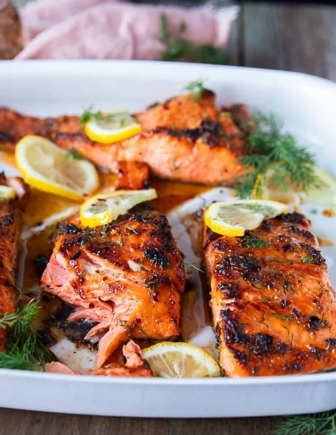 A salmon fillet flaked in a plate showing how succulent and juicy the salmon is