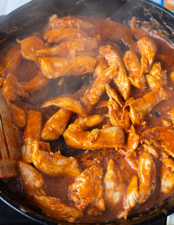 Steaming hot chicken fully cooked in the cast iron skillet and ready