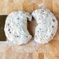 Fougasse dough divided into two halves on a wooden board
