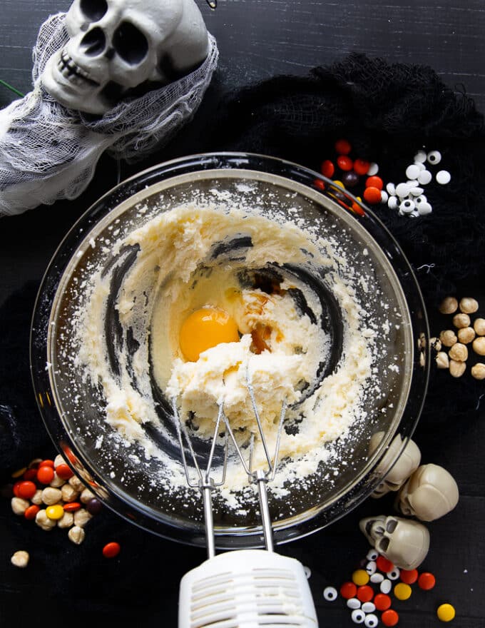 One egg is added to the creamed sugar and butter and vanilla