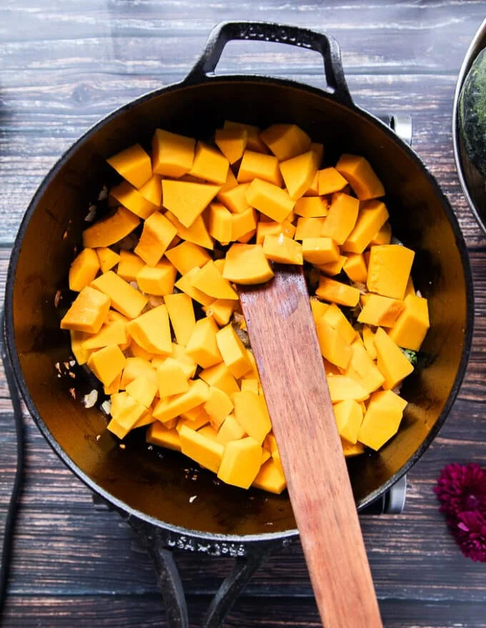 peeled and diced pumpkin added to the pot for cooking risotto