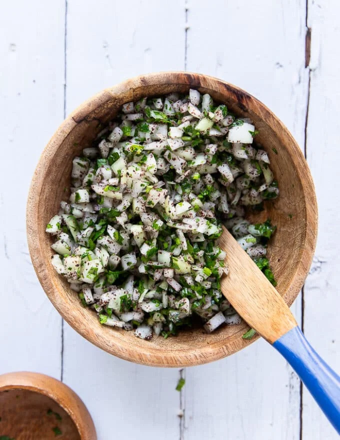 Sumac and onion salad ready in a wooden bowl