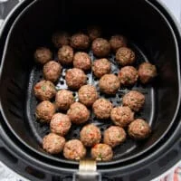 The meatballs are added into an air fryer basket