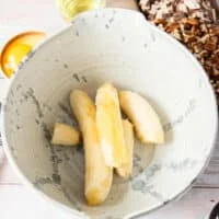 Peeled over ripe bananas in a large bowl ready to mash