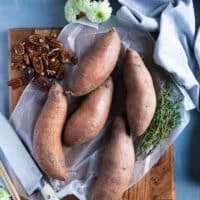 washed sweet potatoes on a cutting board ready to cut