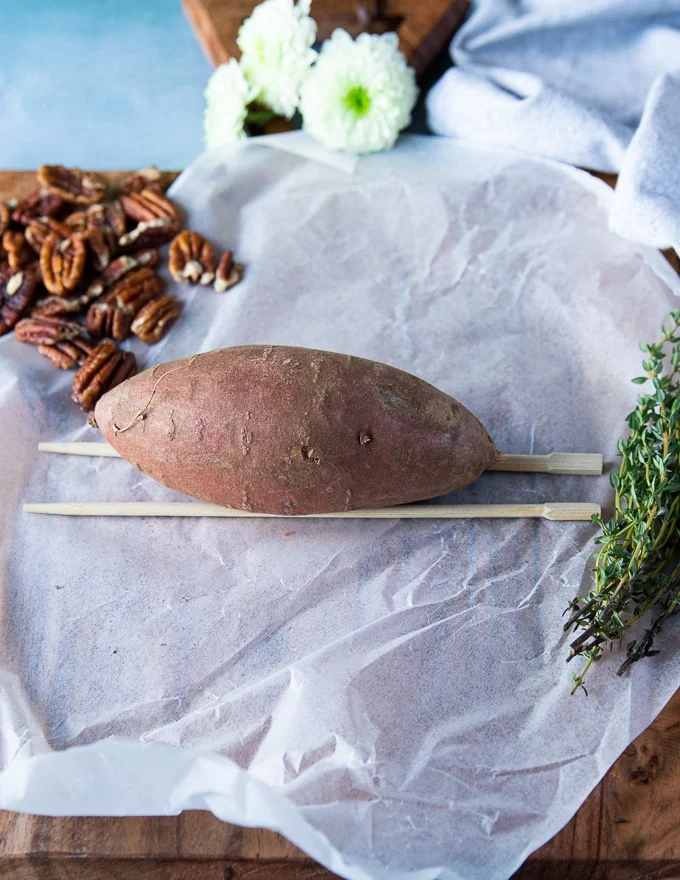 A sweet potato is placed right over the chopsticks